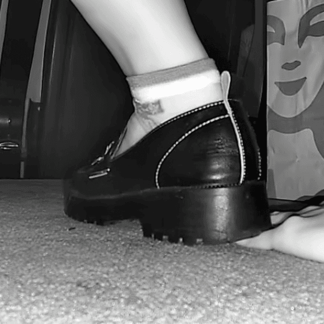 Cinema girl candid stepping on hand with leather shoes