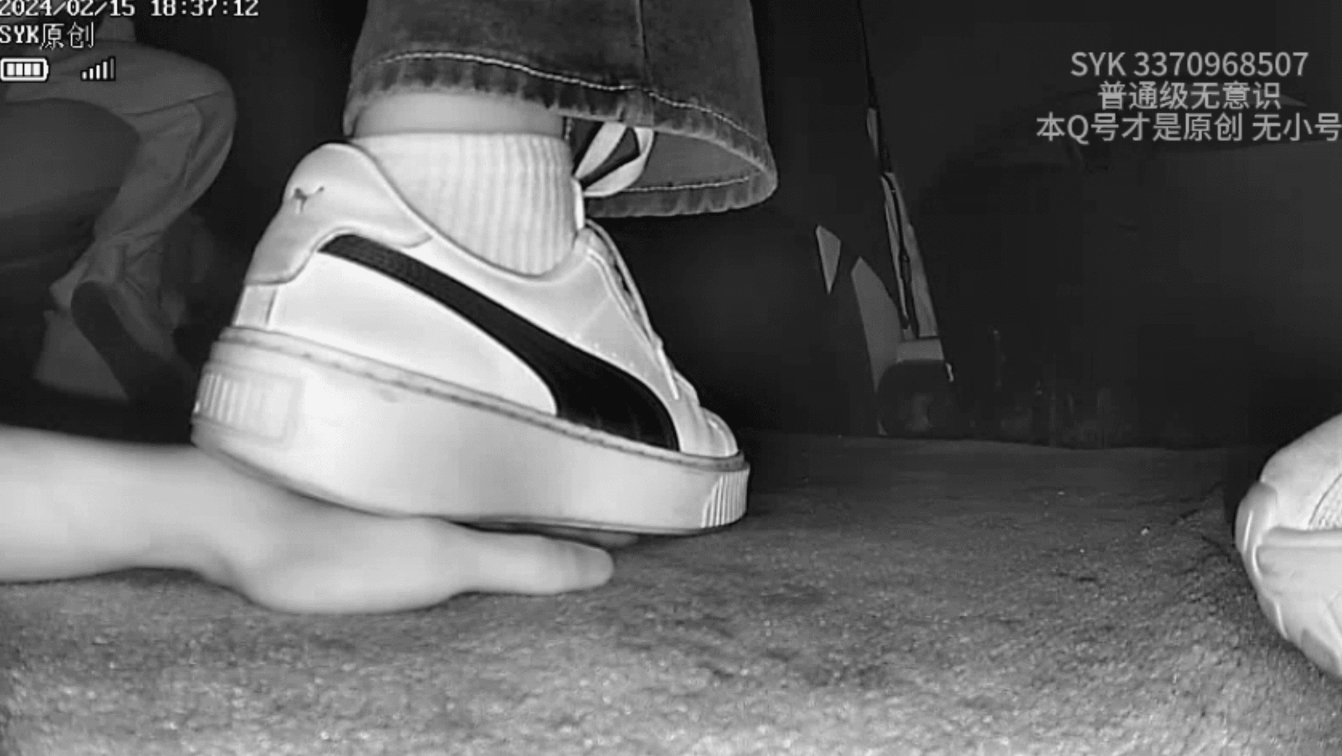 Girl candid hand trample with white socks Puma skate shoes in cinema