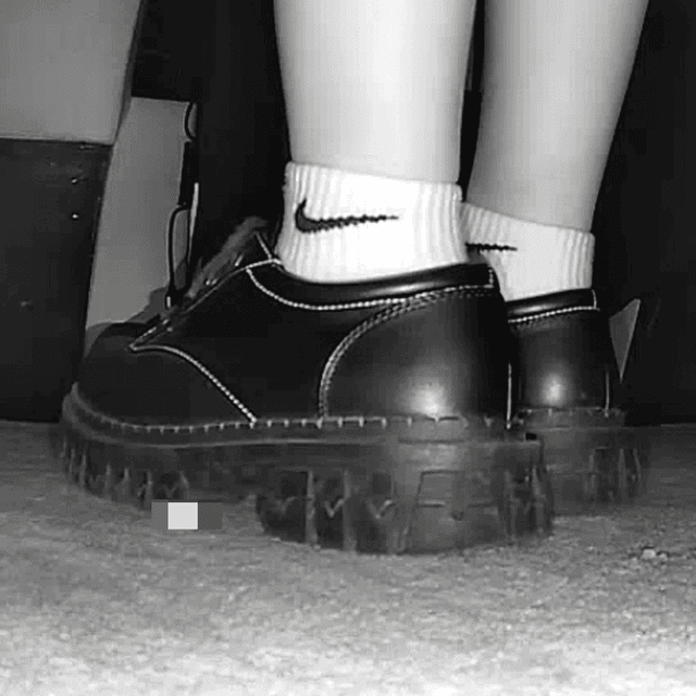 Girl wearing white socks and leather shoes with her boyfriend candid crush at the cinema