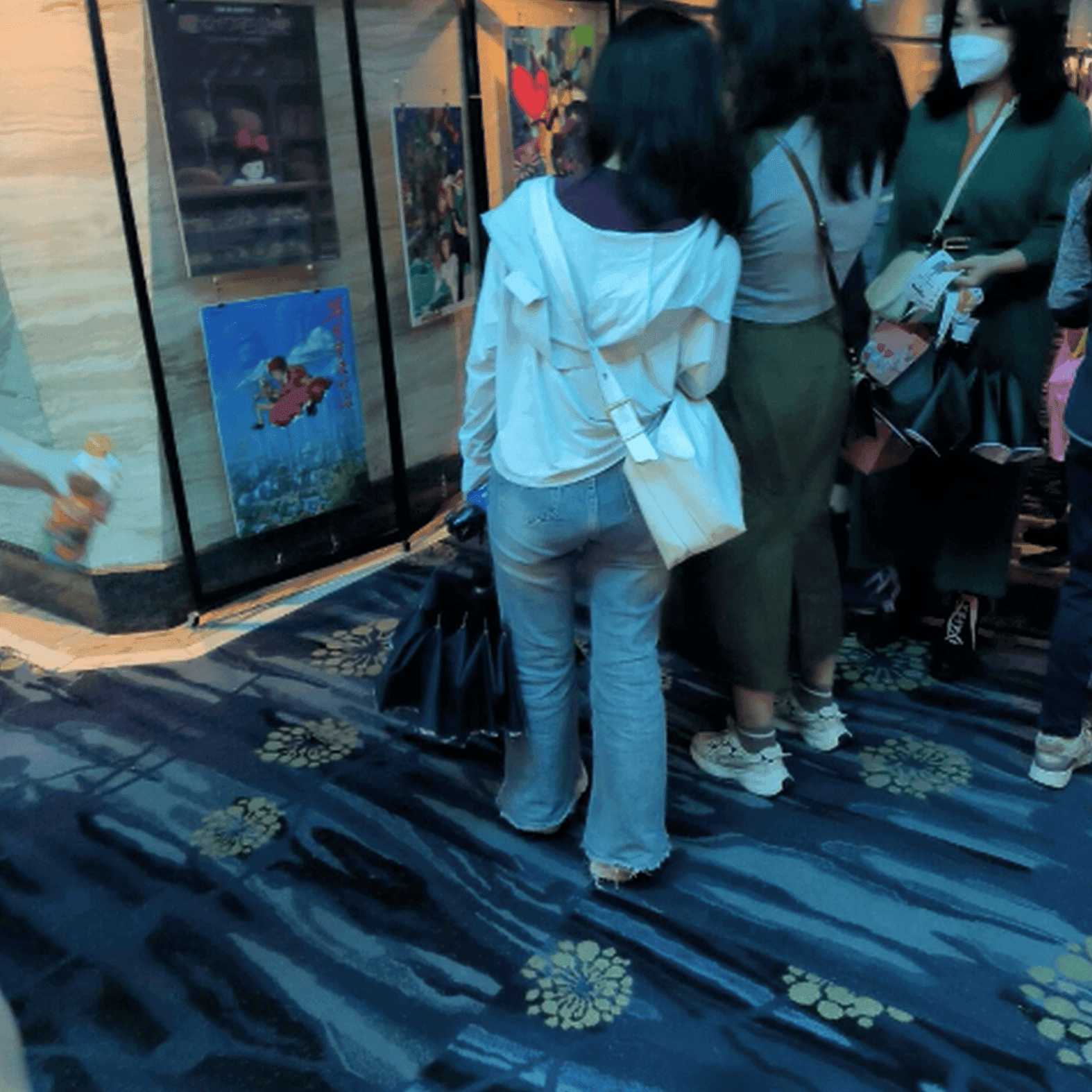 Girl in movie theater candid trample on hand with thick-soled sneakers