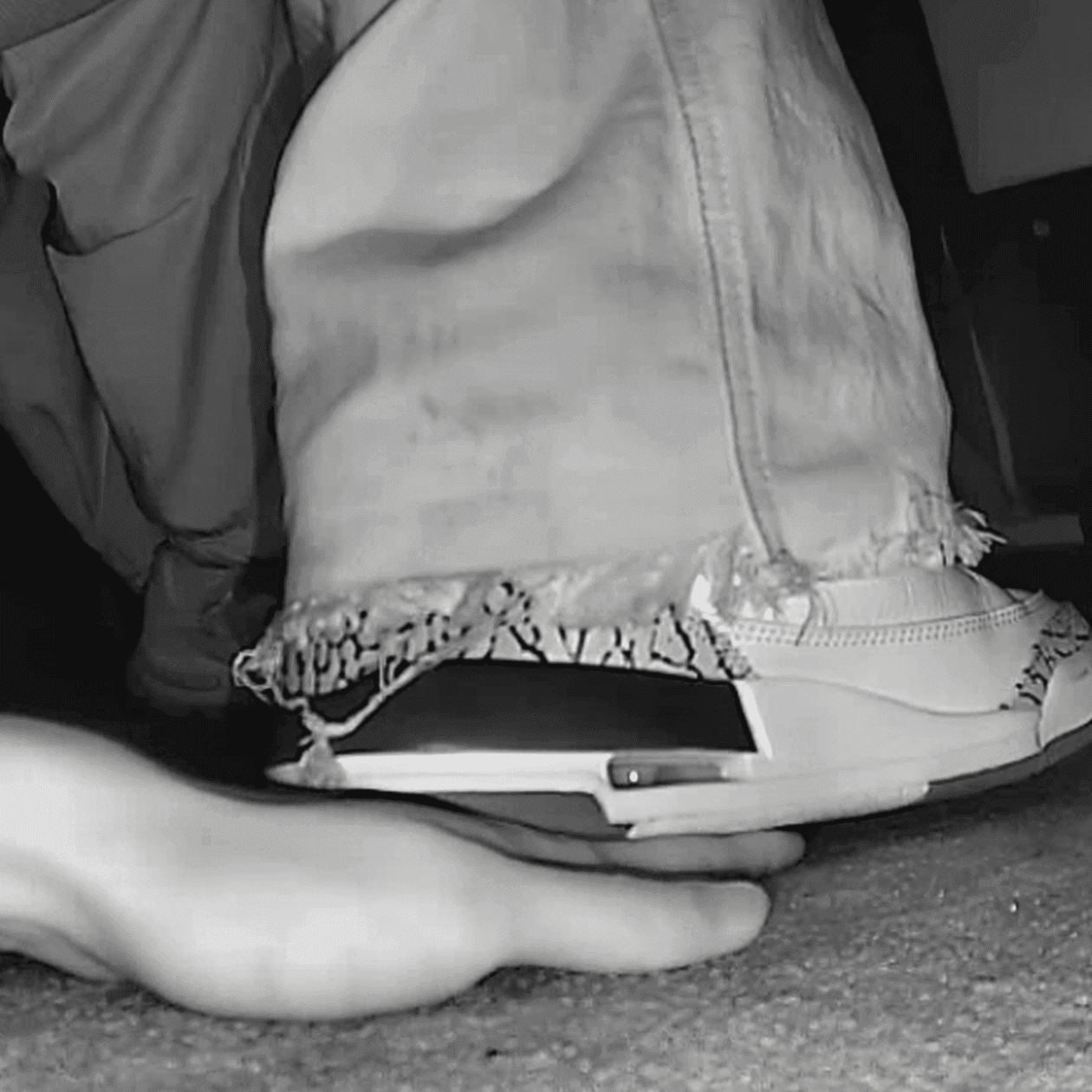 Girl in movie theater candid trample on hand with Nike Air Jordan sneakers