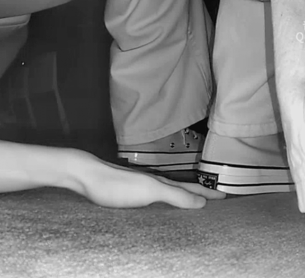 Woman in cinema candid hand trample with Converse and flat shoes