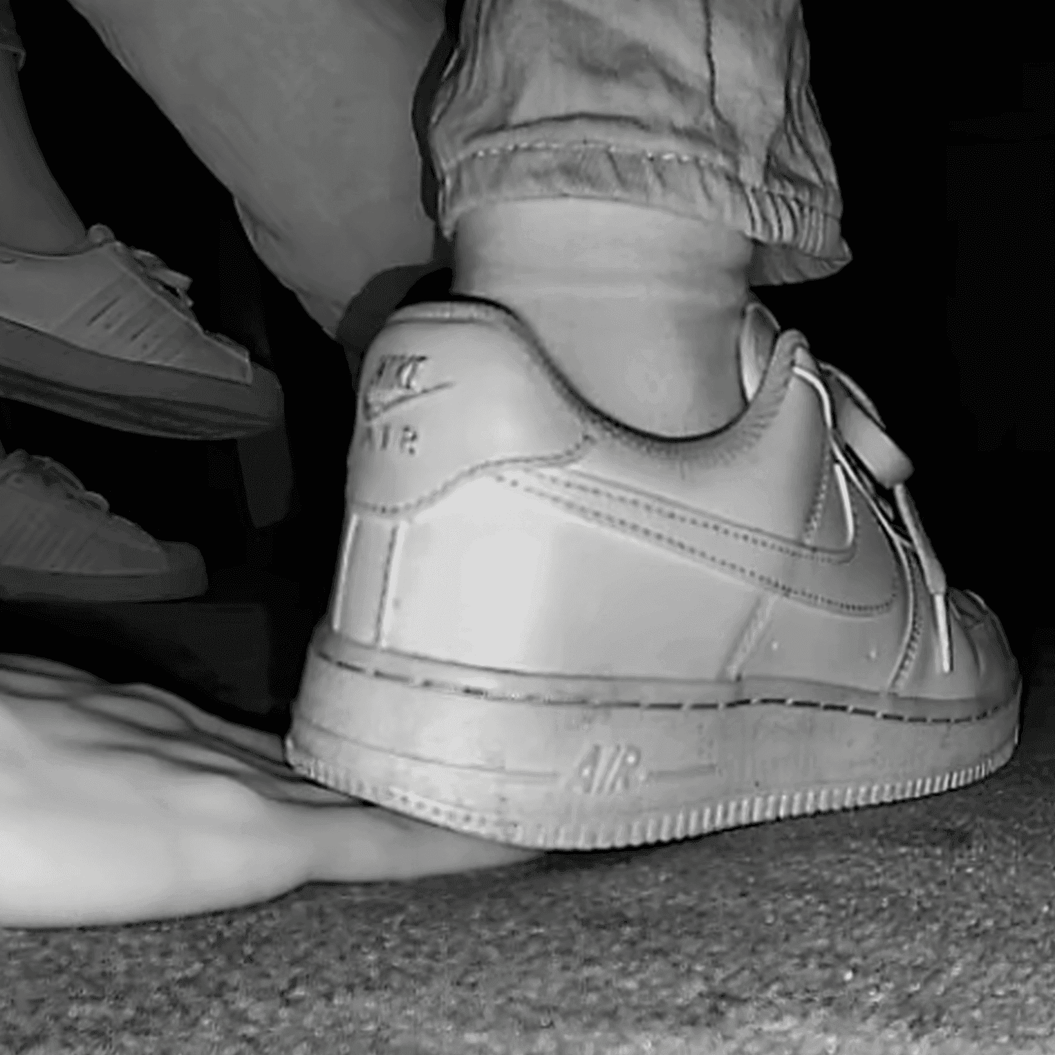 Woman unaware hand trample with Nike Air Force 1 and sneakers at the cinema