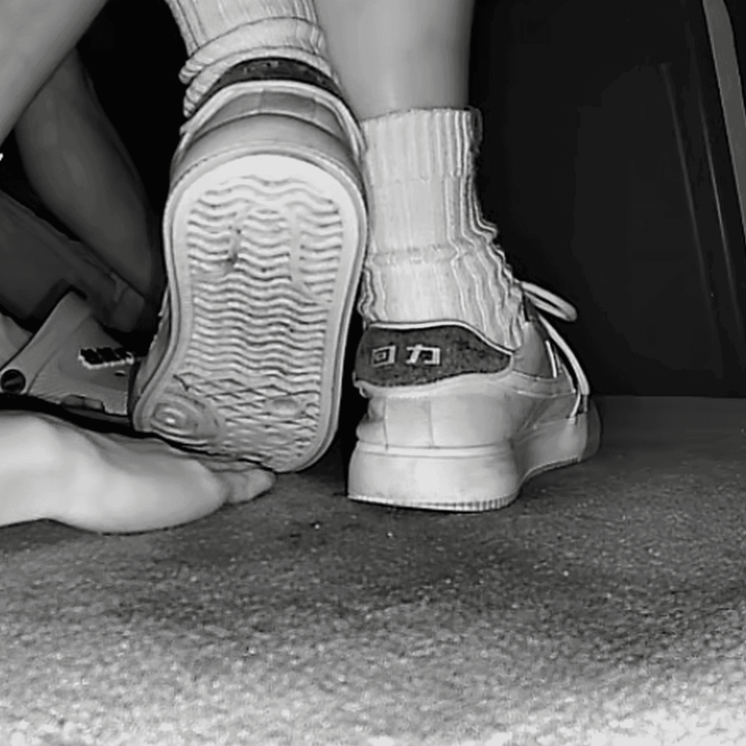 Woman unaware hand trample with Nike Air Force 1 and sneakers at the cinema