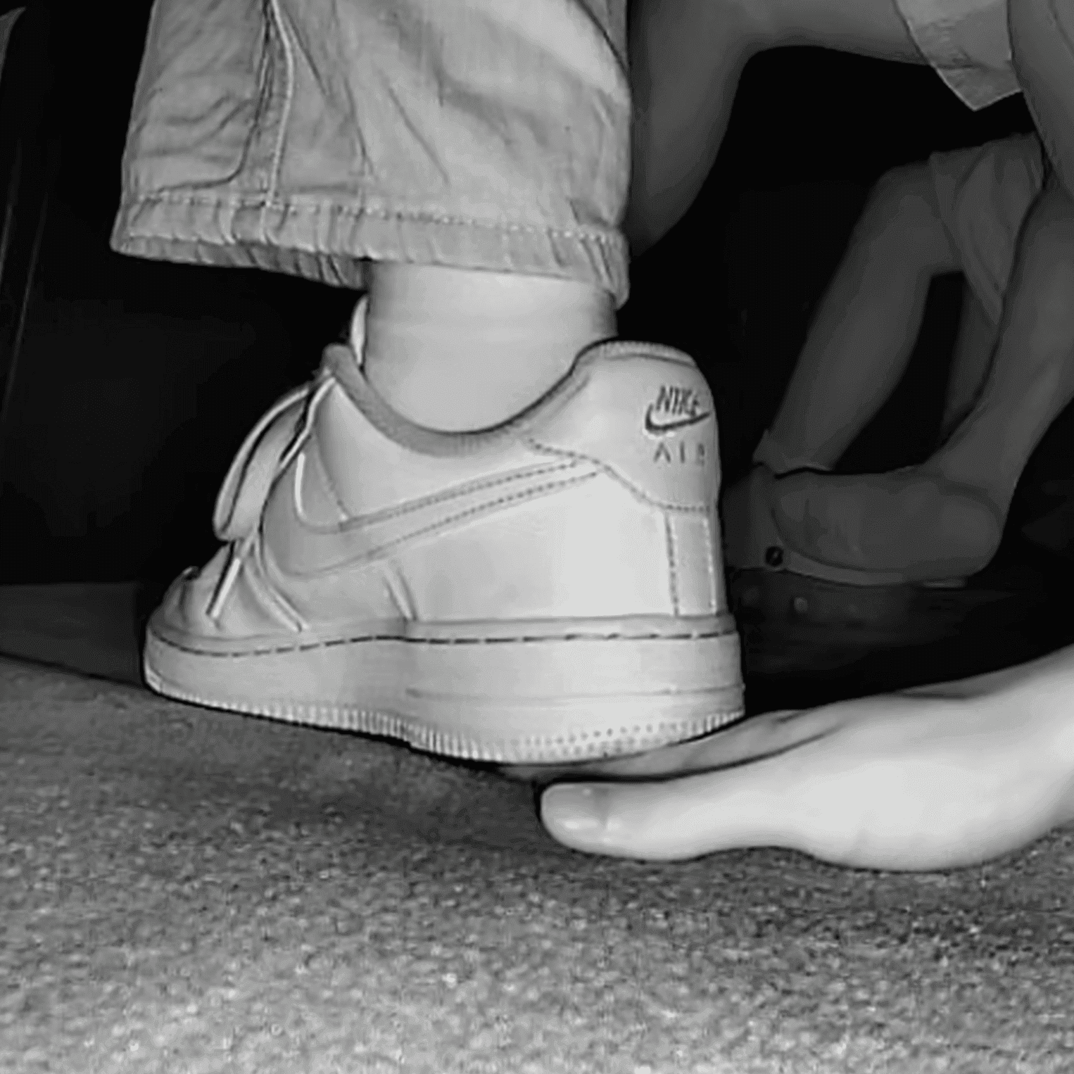 Woman unaware hand trample with Nike Air Force 1 and sneakers at the cinema