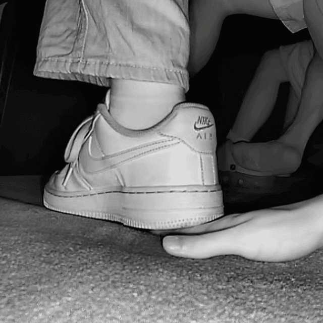 Woman unaware hand trample with Nike Air Force 1 and sneakers at the cinema