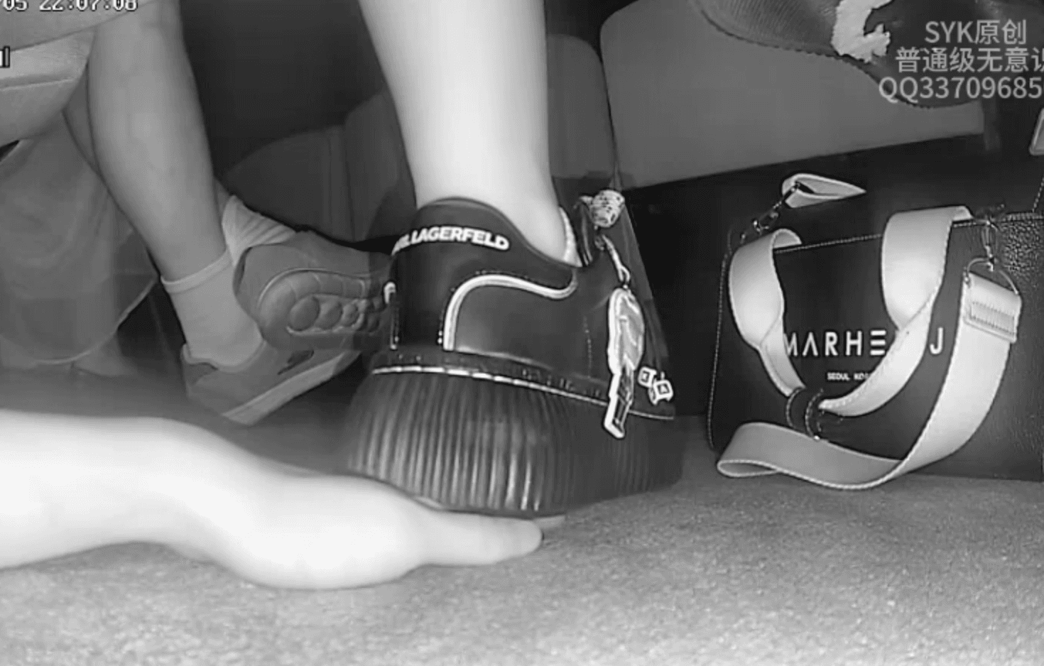 Women in movie theater candid hand trample with white socks and sneakers