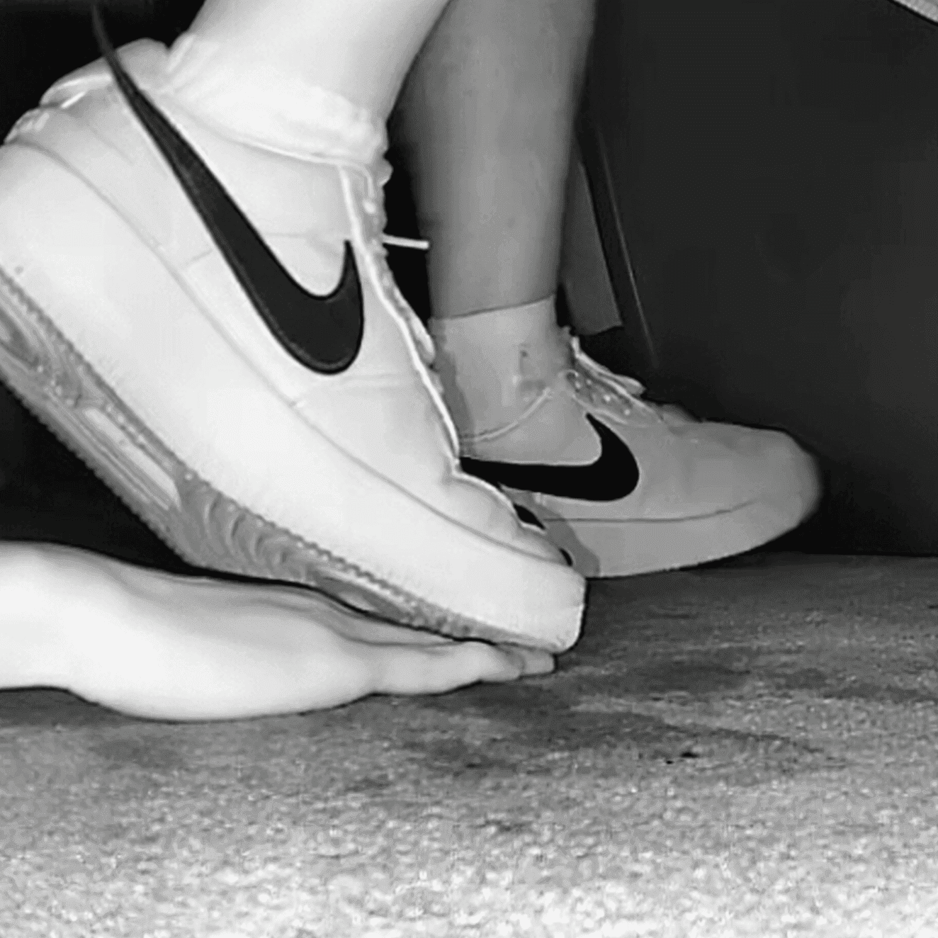 Cinema girl candid stepping on hand with Nike Air Force 1 sneakers