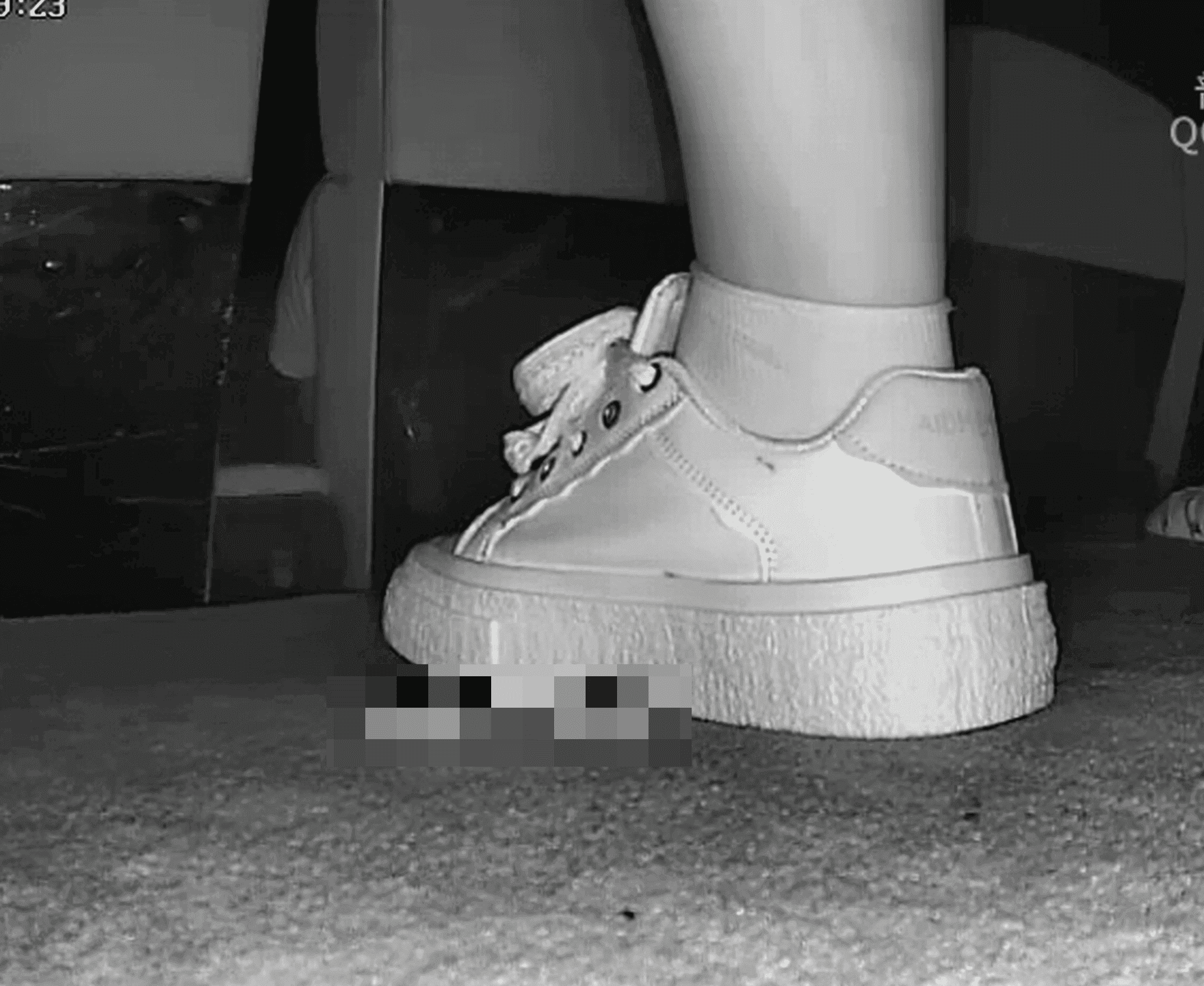 Woman in cinema candid crush with white sneakers