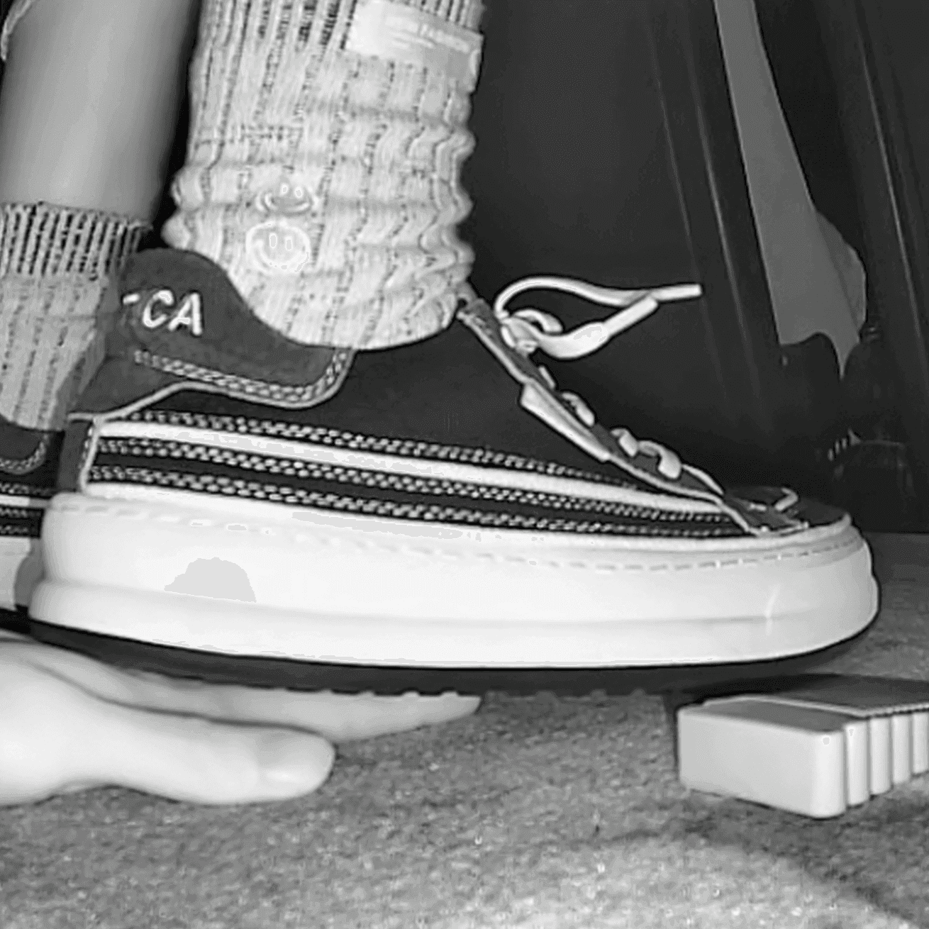 Girl in sneakers candid hand trample at cinema