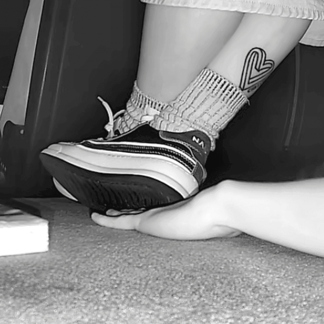 Girl in sneakers candid hand trample at cinema