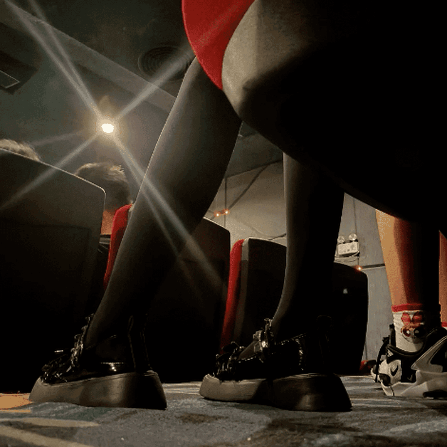 Women in cinema candid hand trample with Martin boots + leather shoes