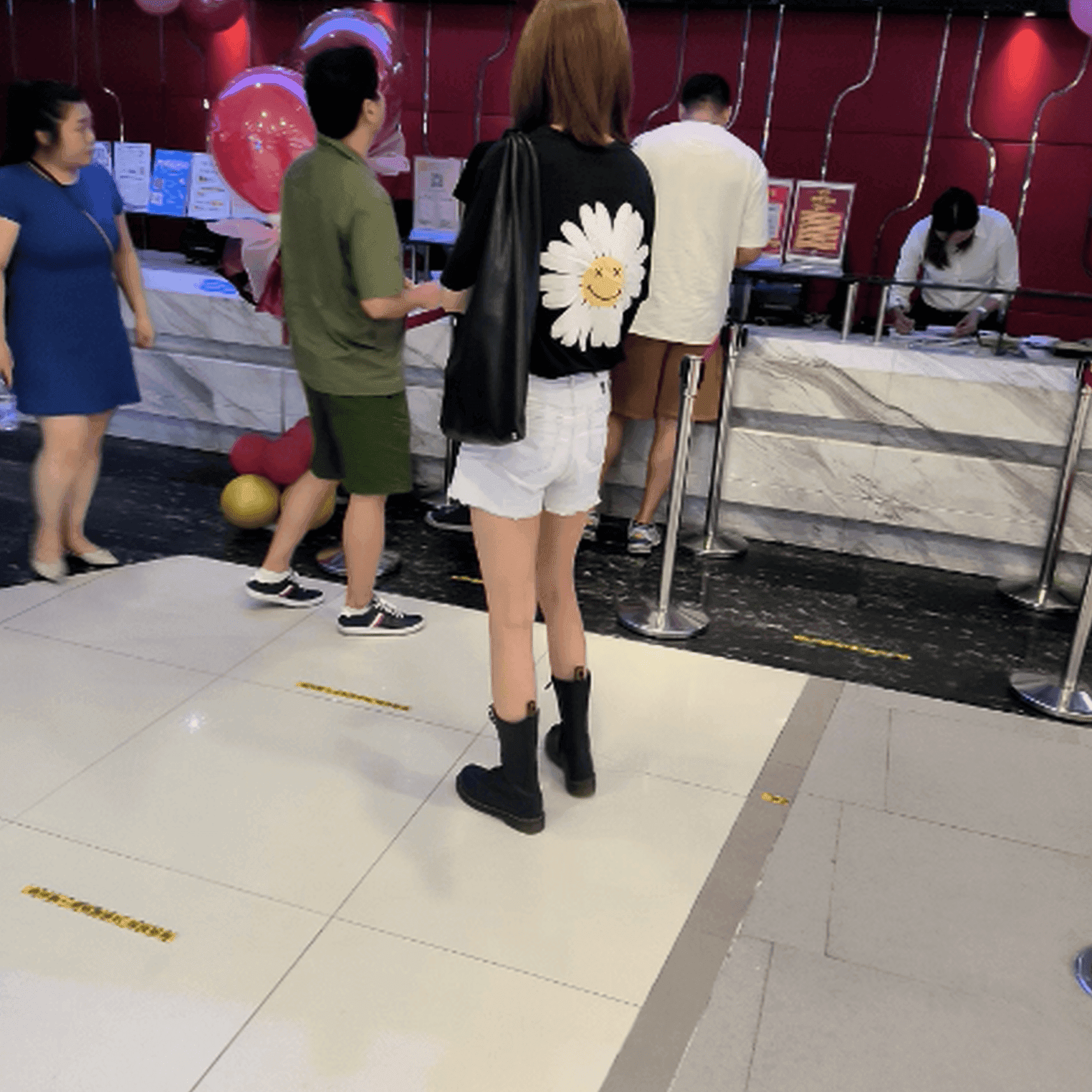 Women in cinema candid hand trample with Martin boots + leather shoes