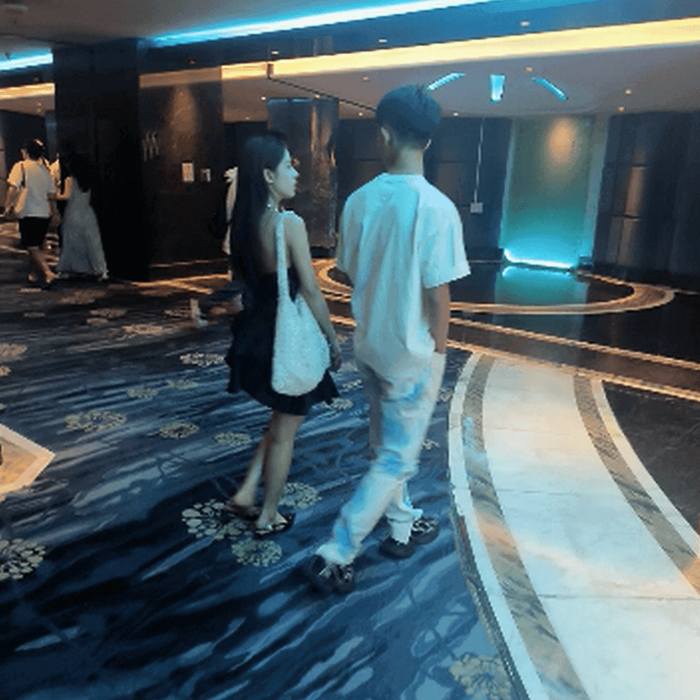 Women in a movie theater candid hand trample with black heels