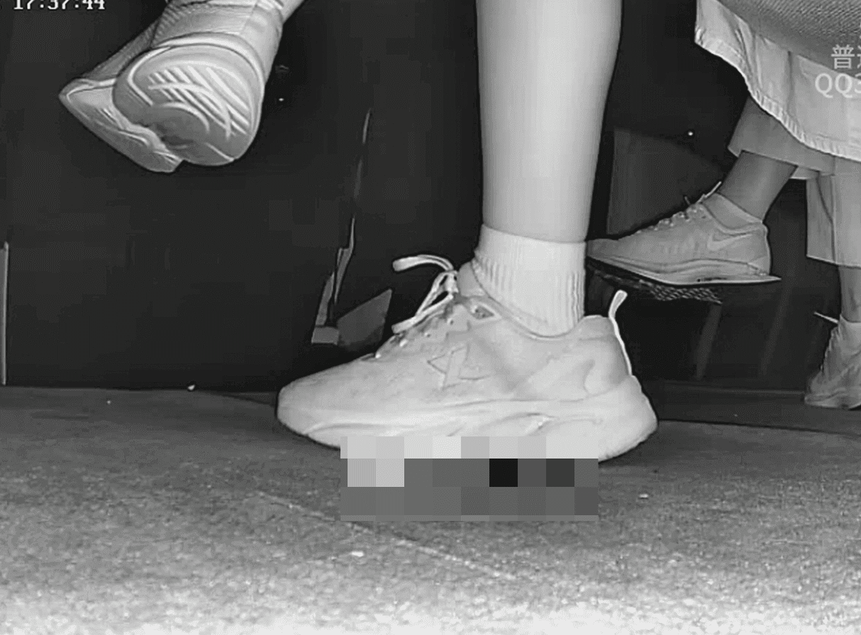 Woman in sneakers and white socks candid crush in movie theater