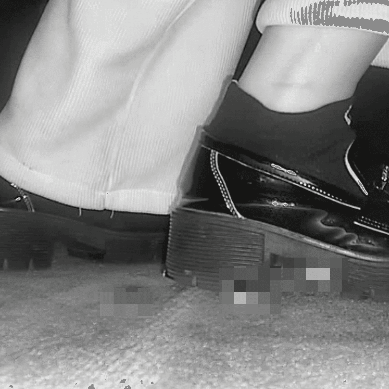 Woman candid crush with black leather shoes in cinema