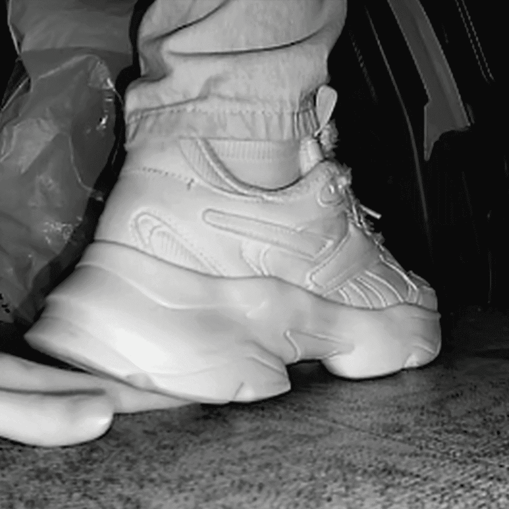 Woman candid crush with Reebok sneaker + sneaker candid hand trample in the cinema
