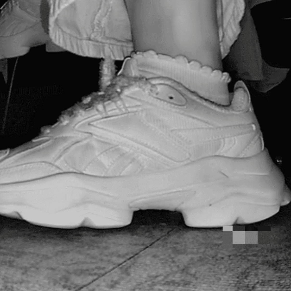 Woman candid crush with Reebok sneaker + sneaker candid hand trample in the cinema