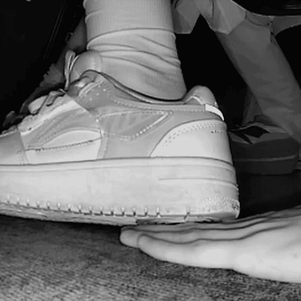 Woman candid crush with Reebok sneaker + sneaker candid hand trample in the cinema