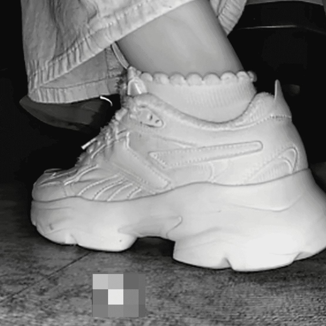 Woman candid crush with Reebok sneaker + sneaker candid hand trample in the cinema