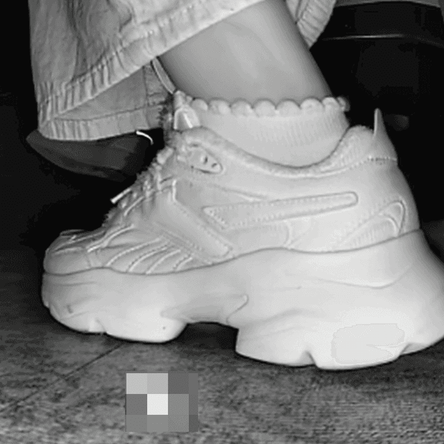 Woman candid crush with Reebok sneaker + sneaker candid hand trample in the cinema
