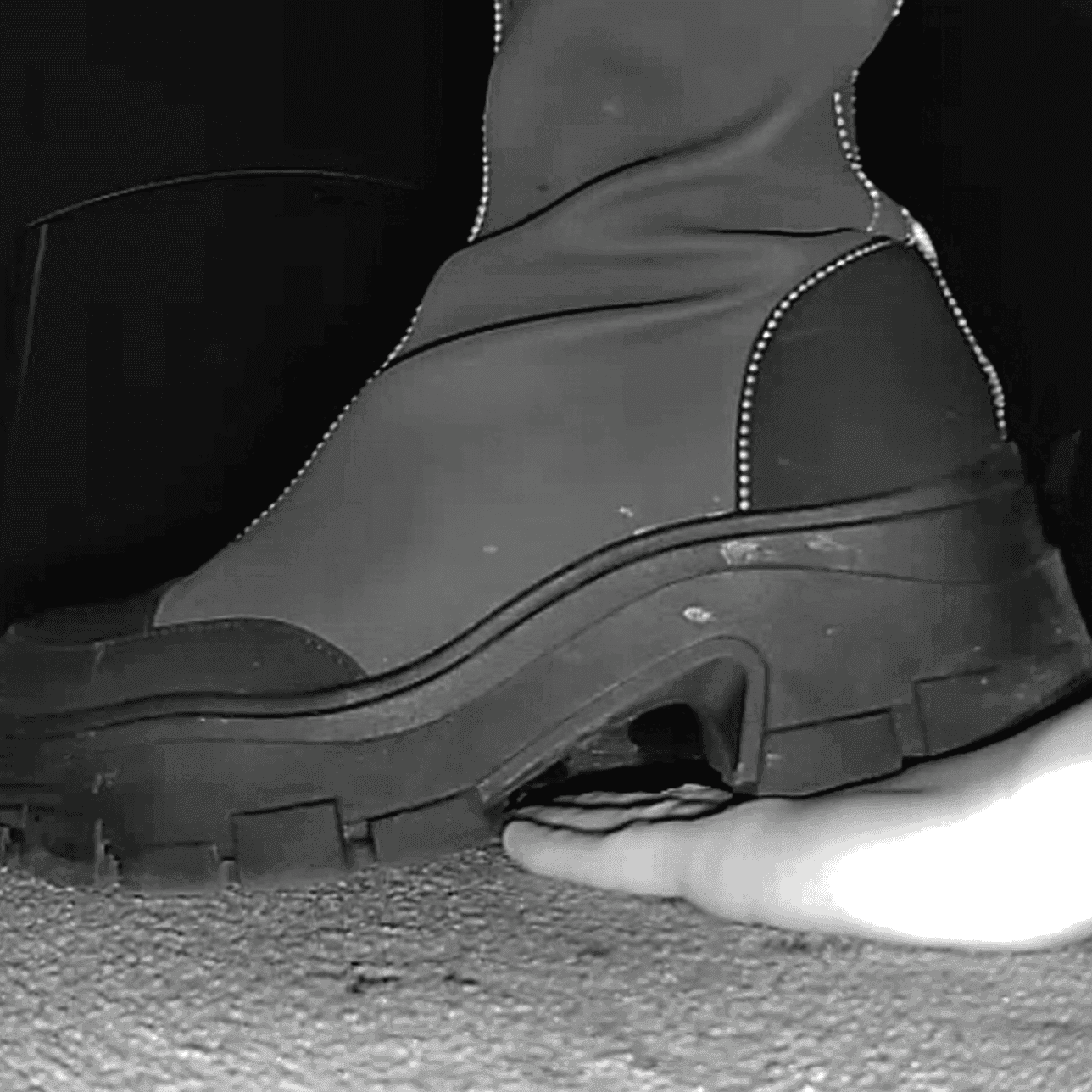 Woman at cinema candid hand trample with chunky-heeled knee-high boots