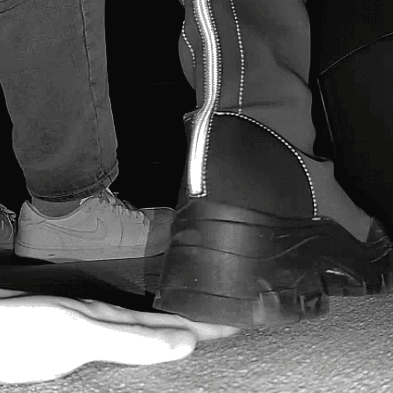 Woman at cinema candid hand trample with chunky-heeled knee-high boots