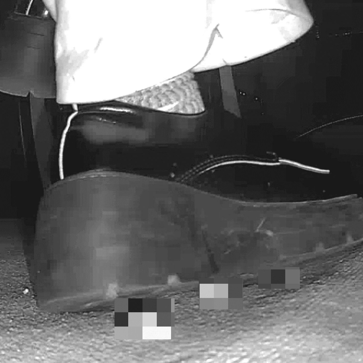 Woman candid crush with black chunky-heel leather shoes at cinema and stuck to the sole