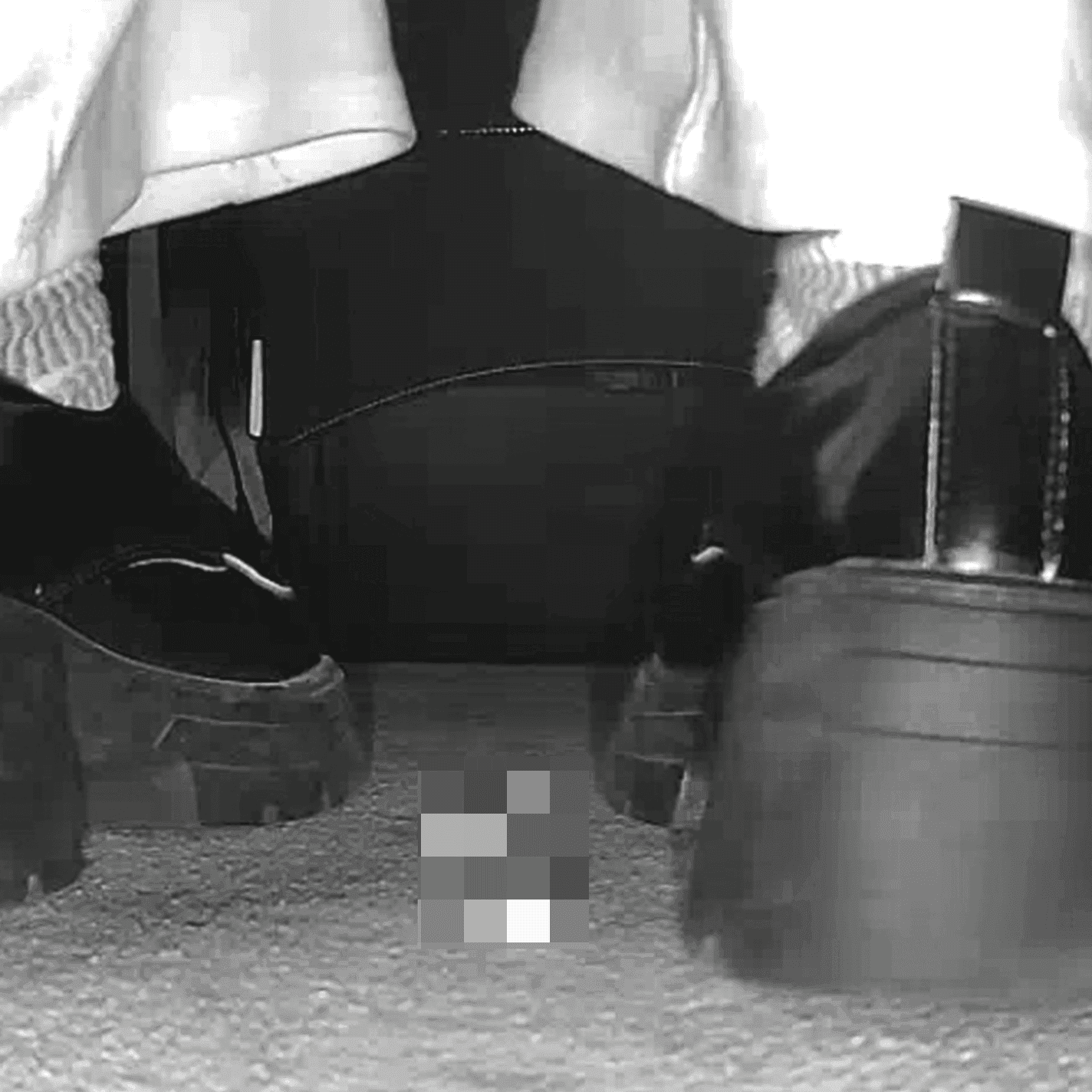 Woman candid crush with black chunky-heel leather shoes at cinema and stuck to the sole