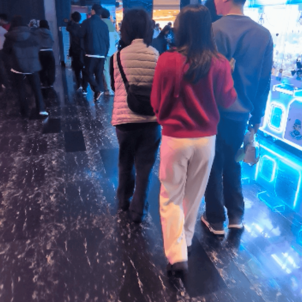 Woman candid crush with black chunky-heel leather shoes at cinema and stuck to the sole