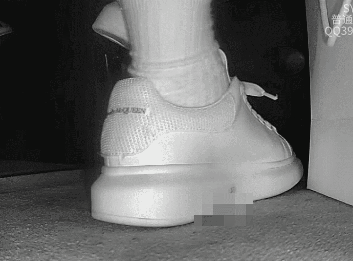 Woman candid crush with white socks and McQueen sneakers in cinema