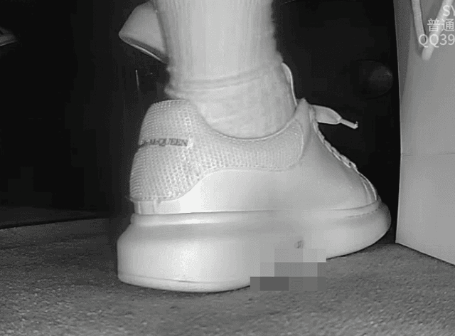 Woman candid crush with white socks and McQueen sneakers in cinema