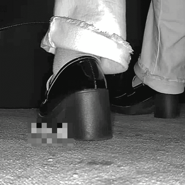 Woman with black chunky heeled shoes candid crush in movie theater
