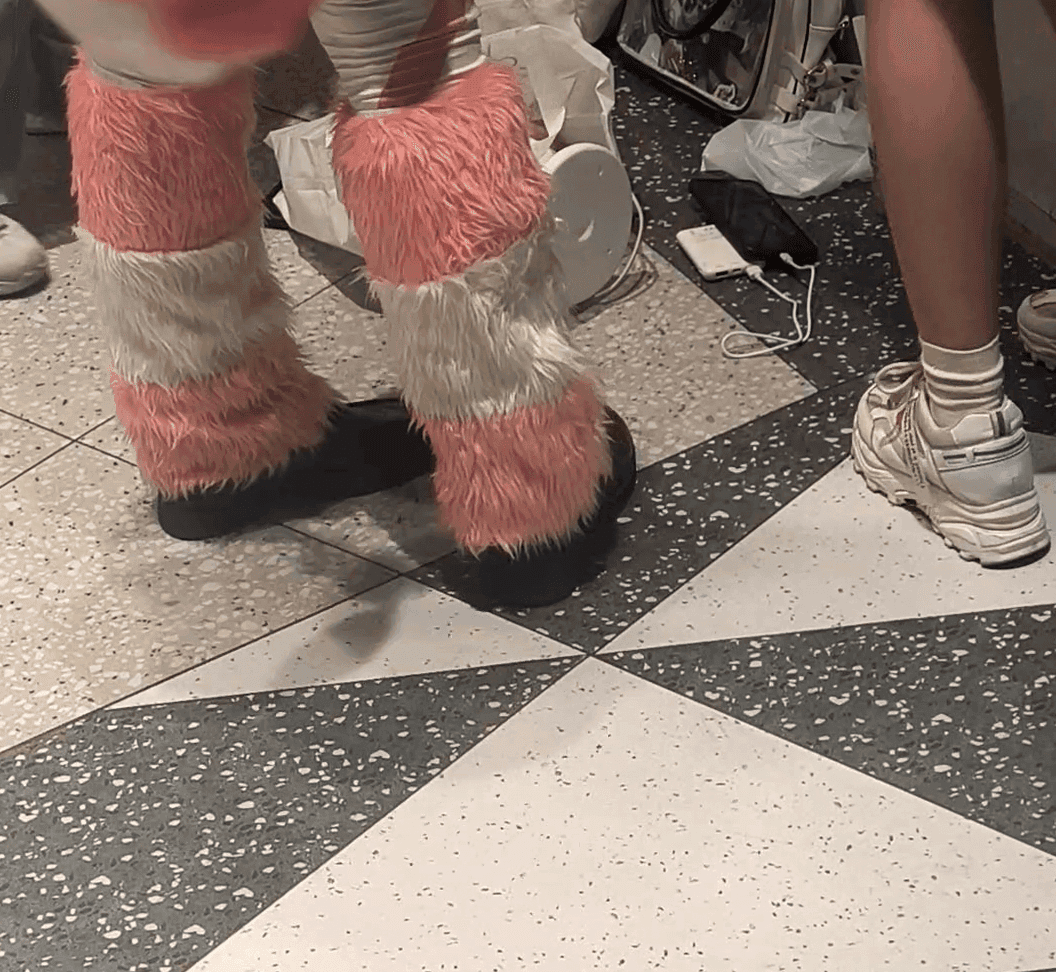 Woman in stockings and leather shoes candid crush at anime convention