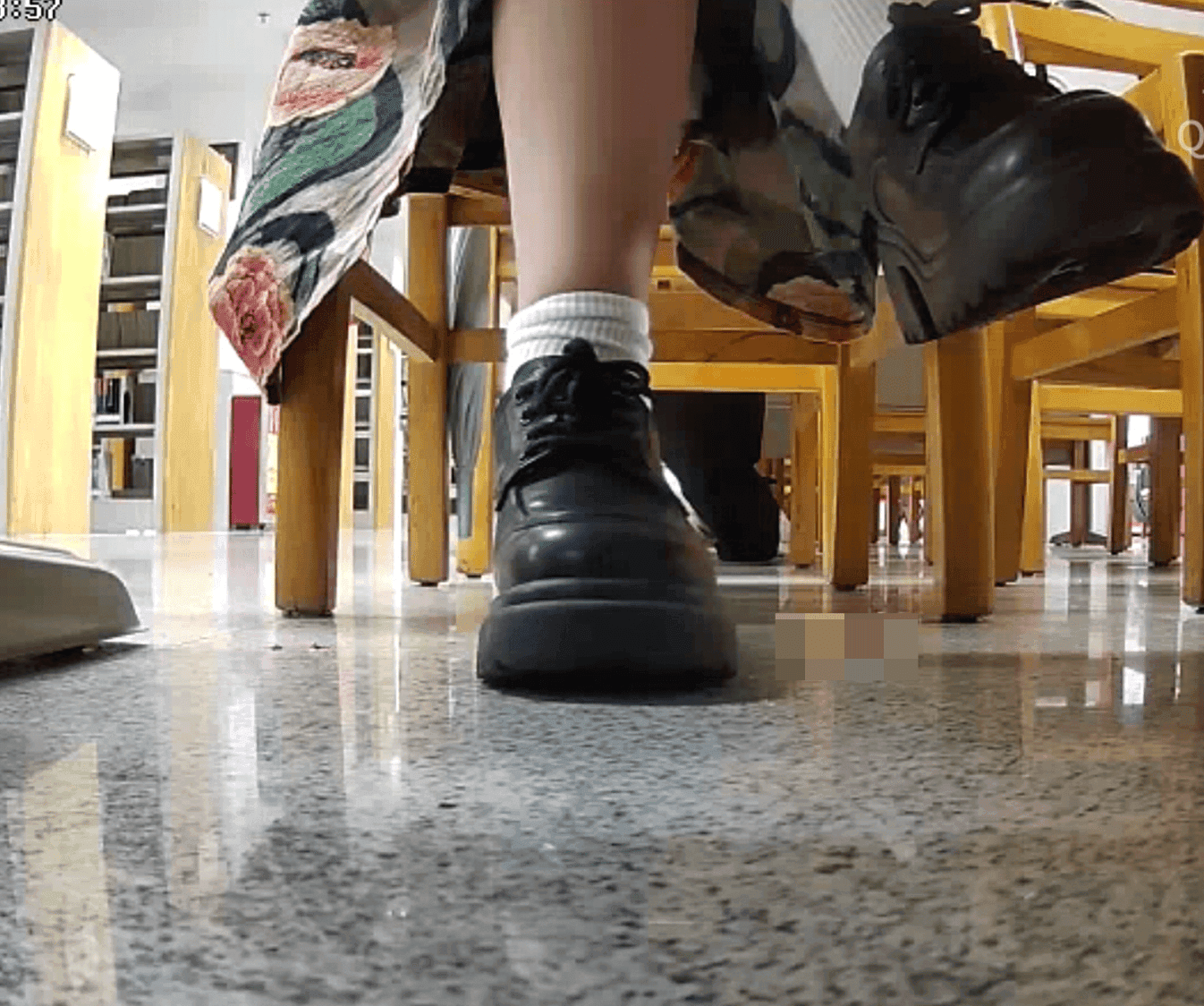 Woman in chunky heels candid crush under the library table