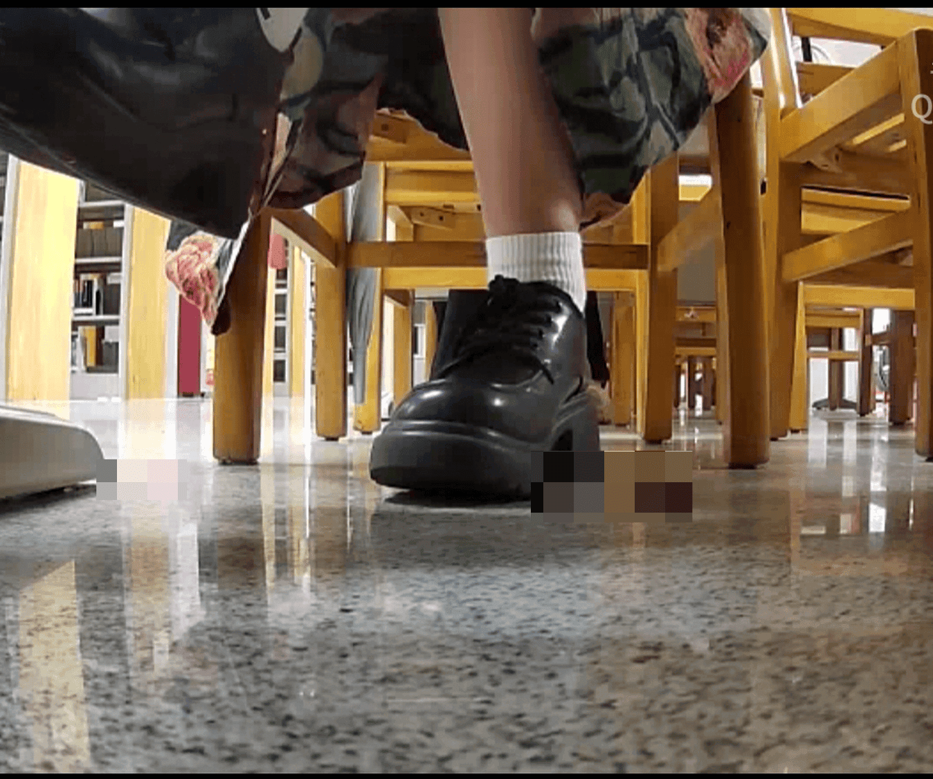 Woman in chunky heels candid crush under the library table