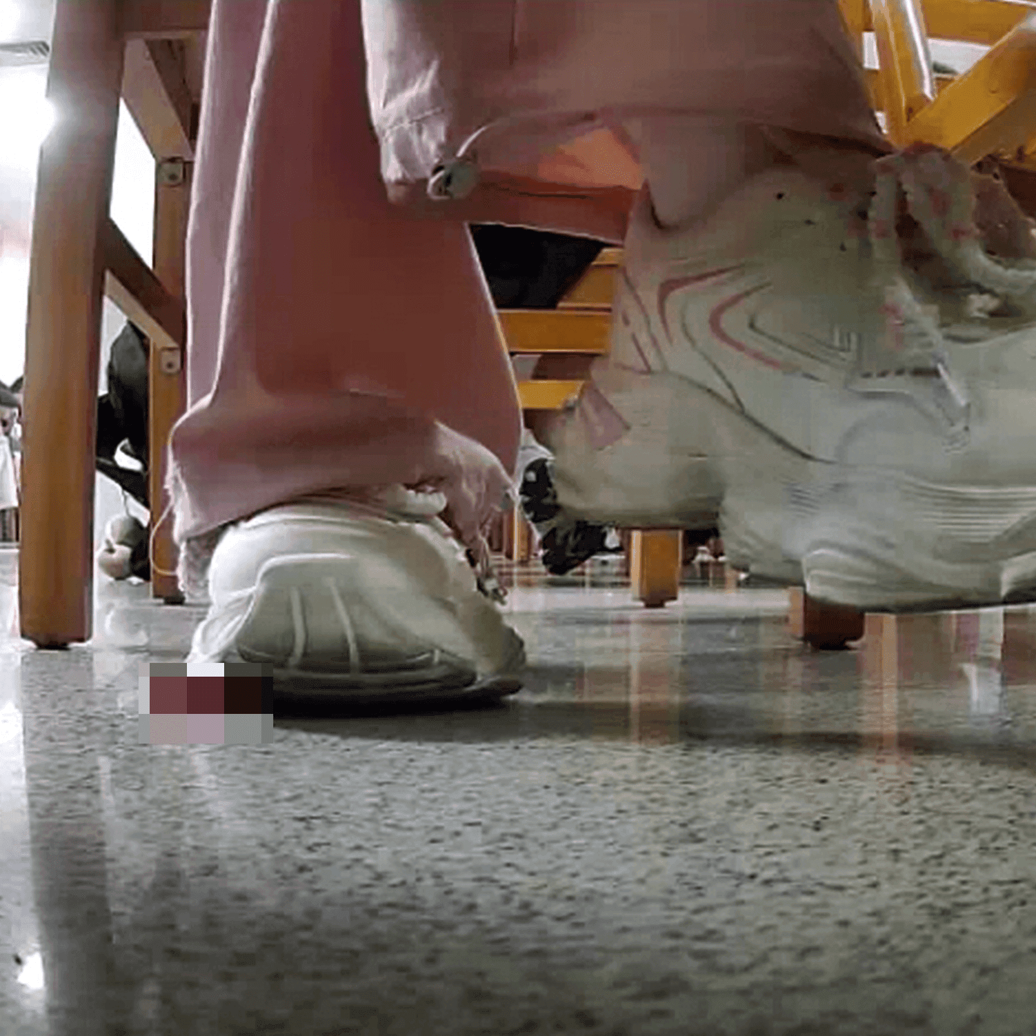 Woman in white sneaker candid crush under the library table