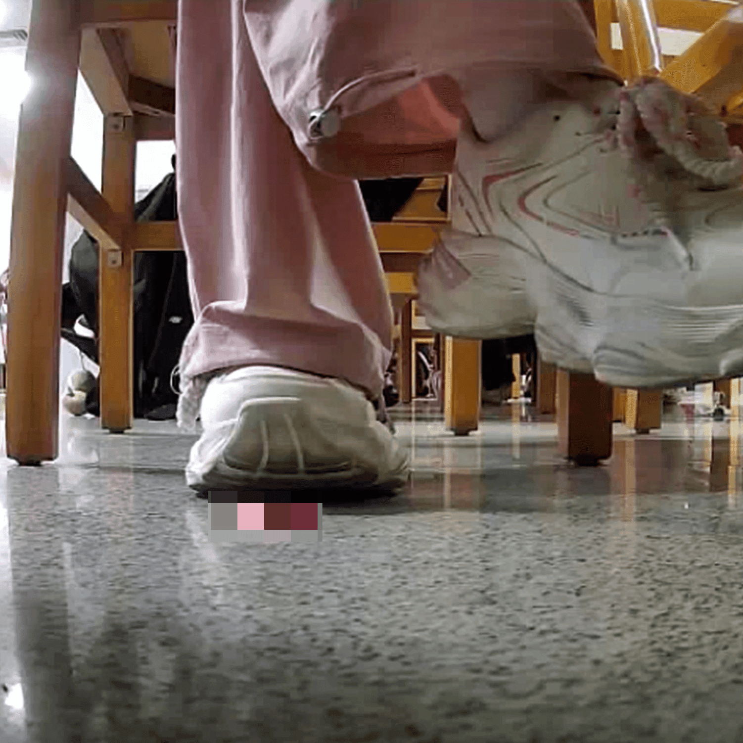 Woman in white sneaker candid crush under the library table
