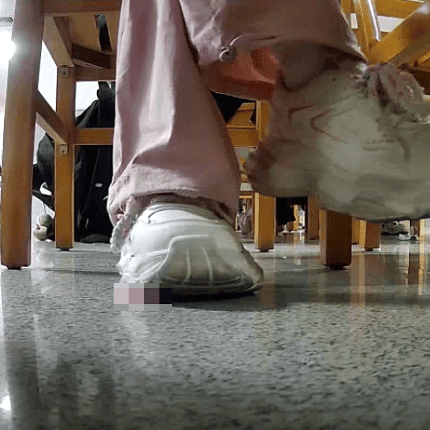Woman in white sneaker candid crush under the library table