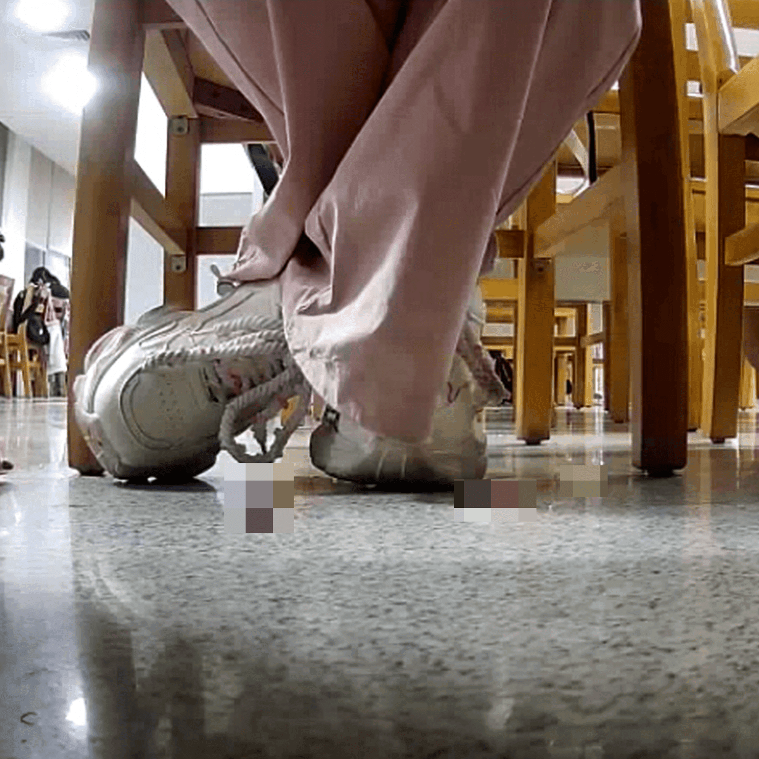 Woman in white sneaker candid crush under the library table