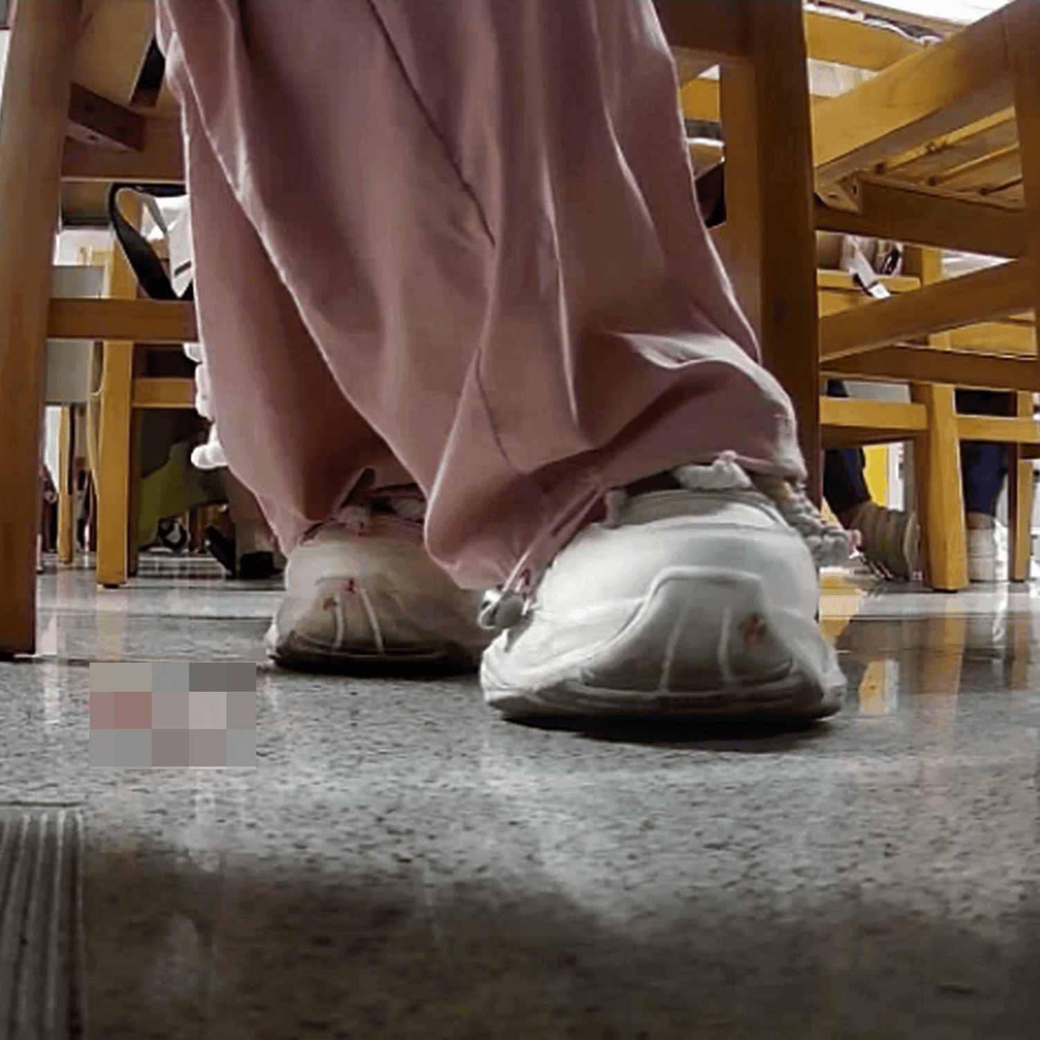 Woman in white sneaker candid crush under the library table
