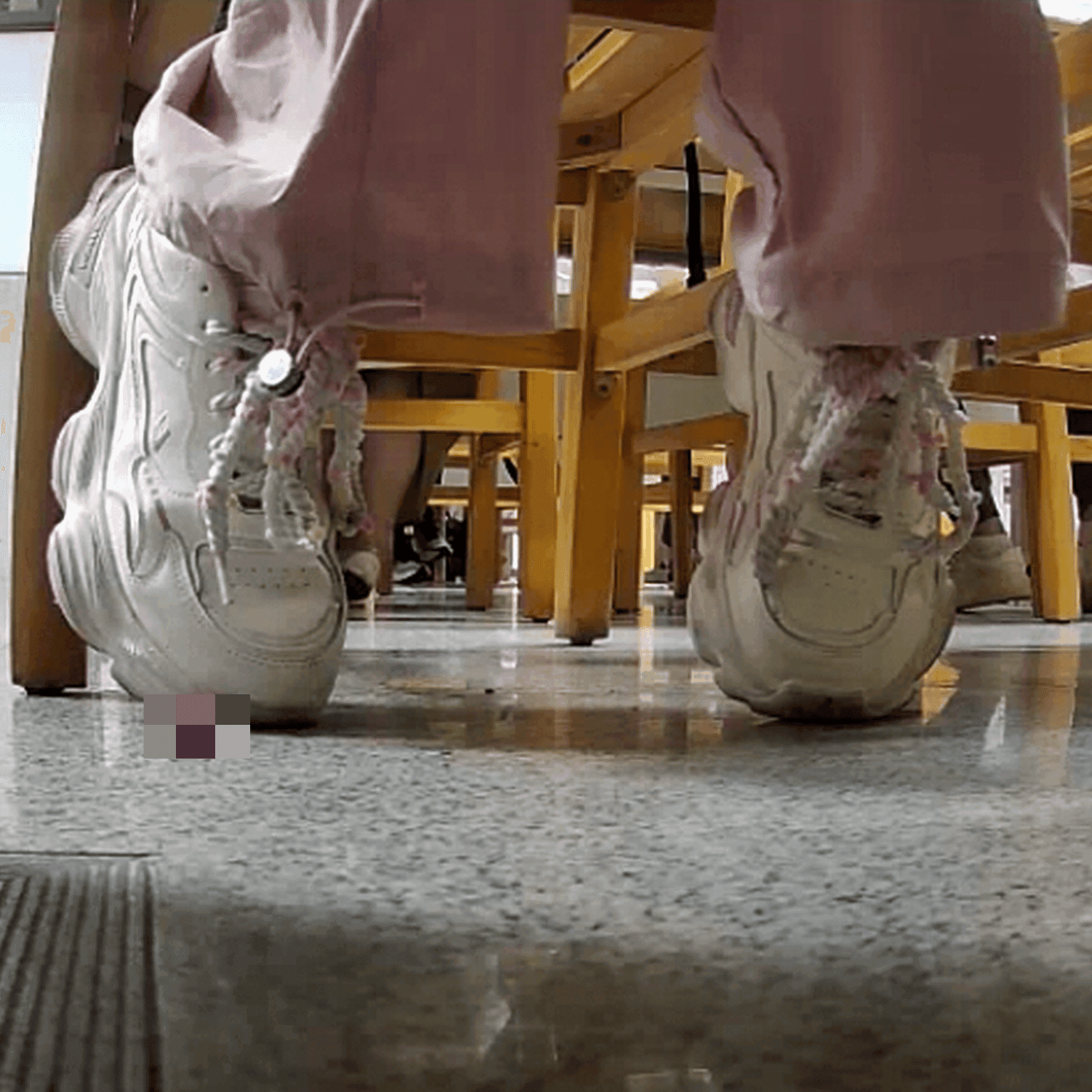Woman in white sneaker candid crush under the library table