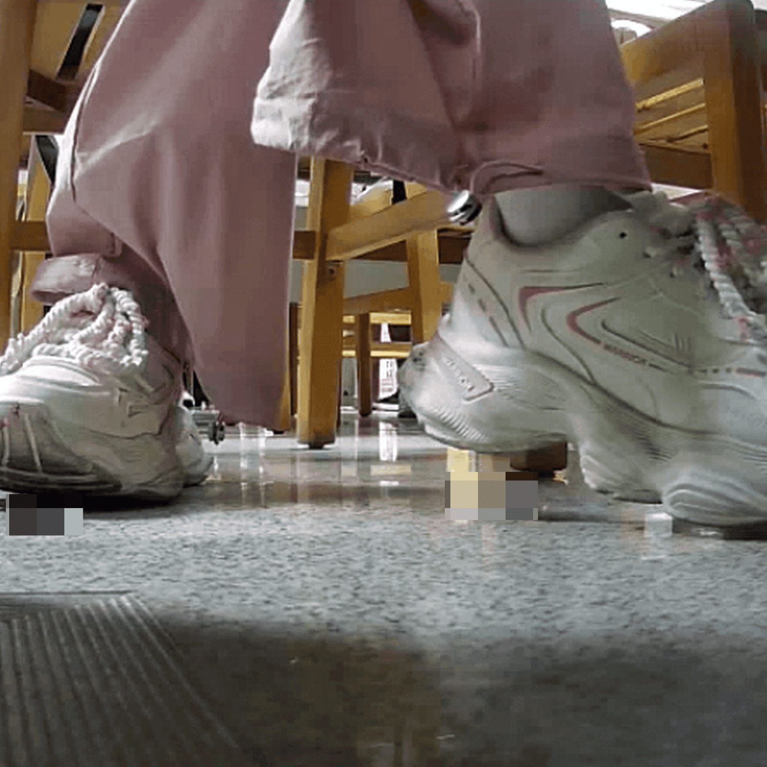 Woman in white sneaker candid crush under the library table