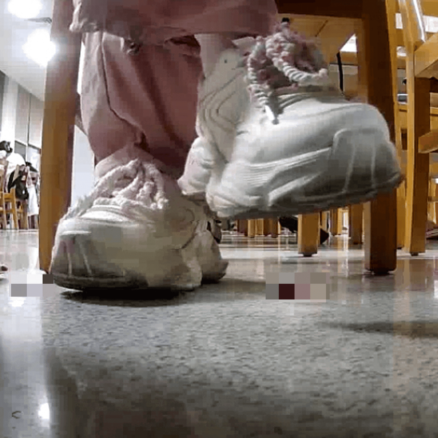 Woman in white sneaker candid crush under the library table