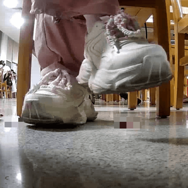 Woman in white sneaker candid crush under the library table