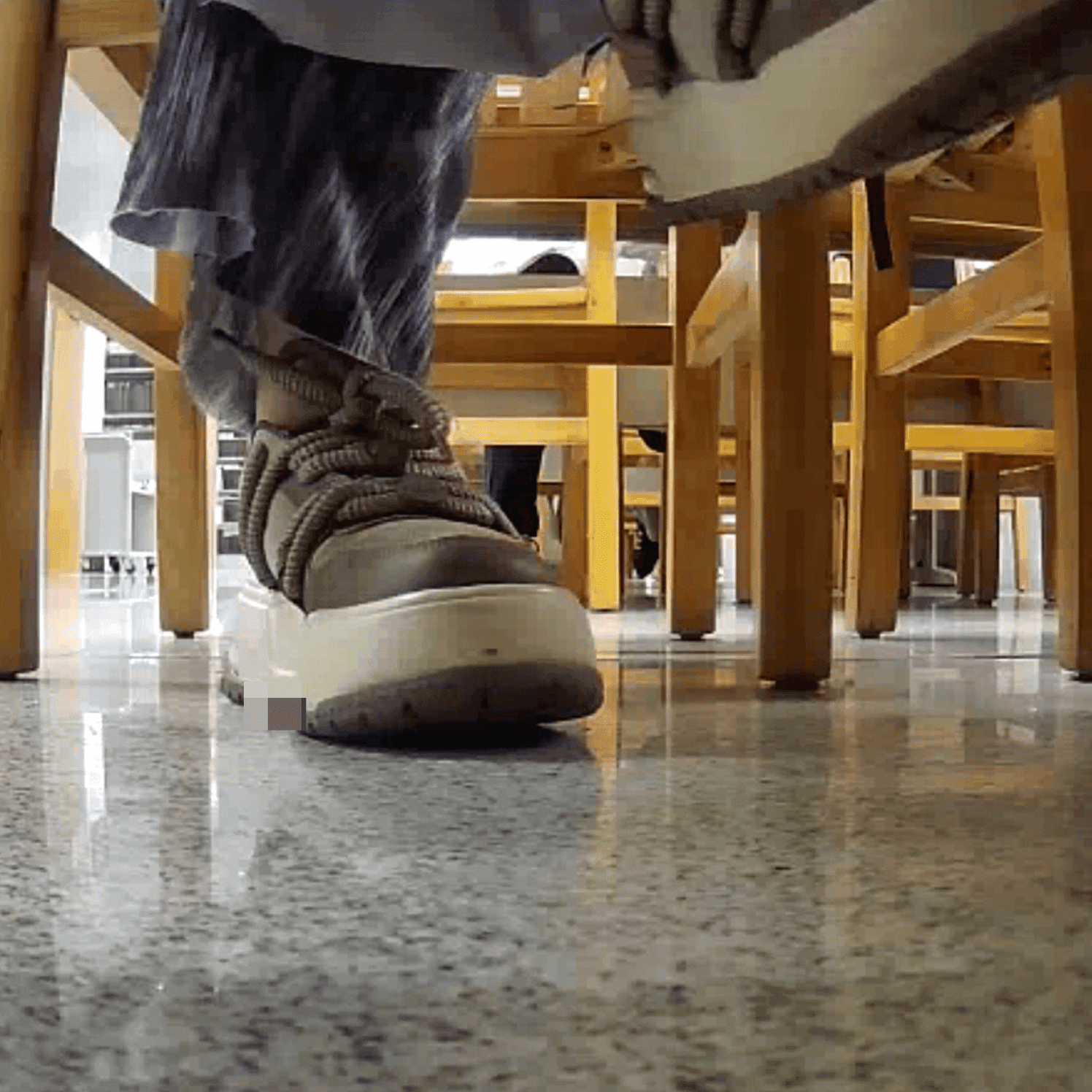 Woman at the library candid crush with the toe of her sneaker