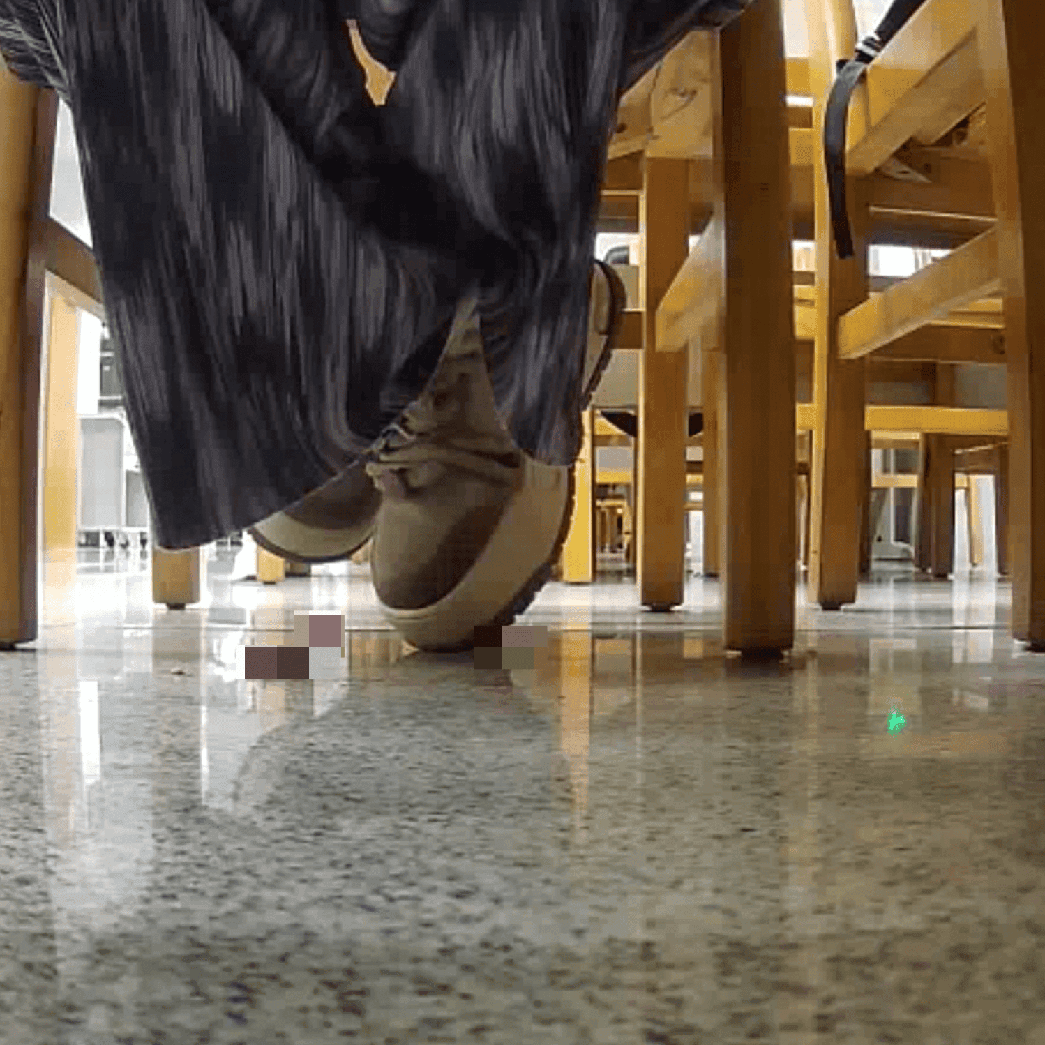 Woman at the library candid crush with the toe of her sneaker