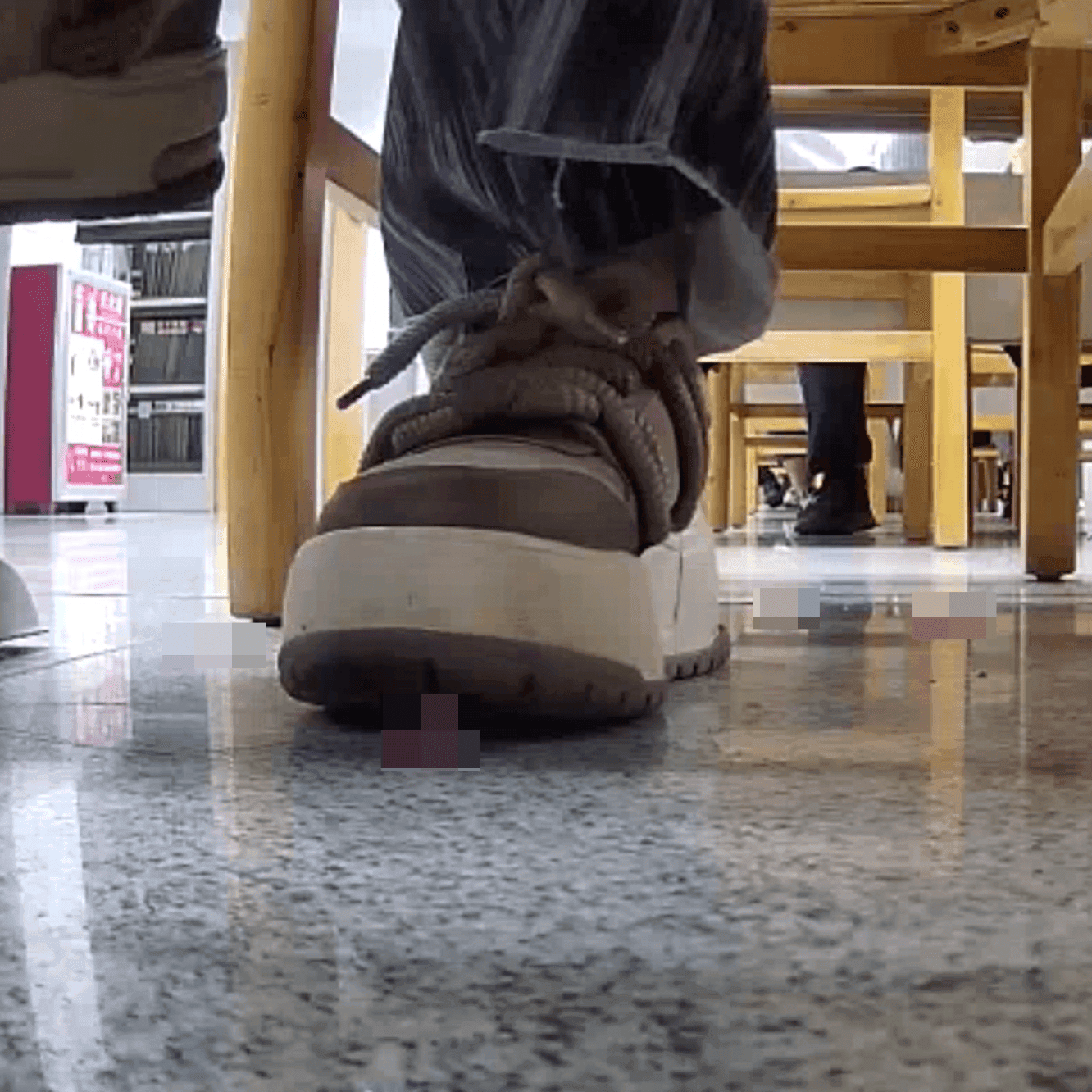 Woman at the library candid crush with the toe of her sneaker