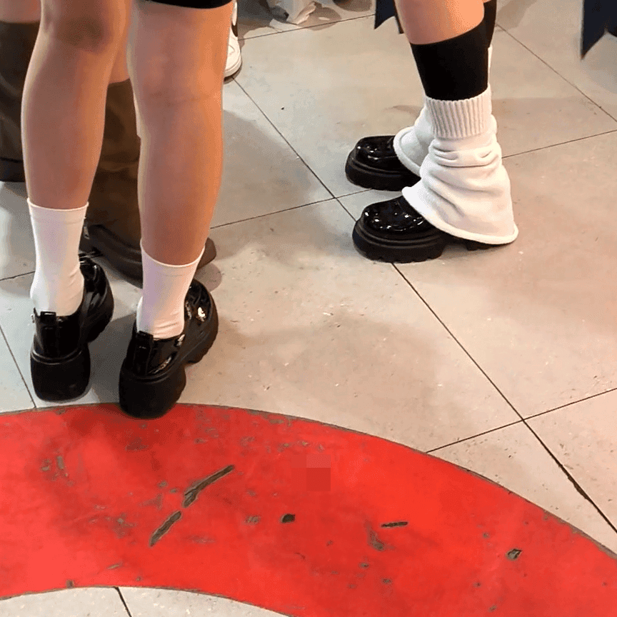 Anime convention cosplay woman in white stockings and leather shoes candid crush