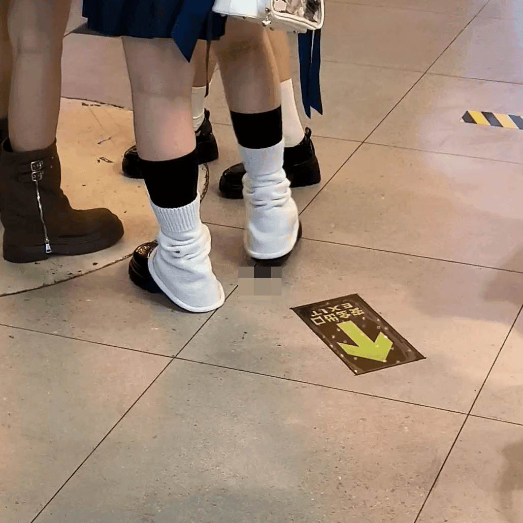 Anime convention cosplay woman in white stockings and leather shoes candid crush